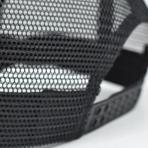 Detail of breathable black mesh and adjustable snapback closure on a trucker hat