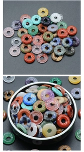Detailed view of colorful natural agate crystal ring pendants in various textures and stones