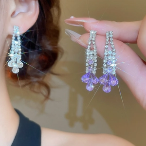 Detailed close-up of crystal tassel earrings with purple water-drop pendants and diamonds