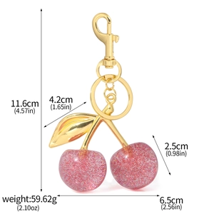 Détails du porte-clés cerise avec remplissage pailleté et dimensions sur alliage doré