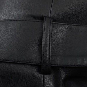 Dettaglio ravvicinato della trama in finta pelle nera con cuciture sartoriali precise