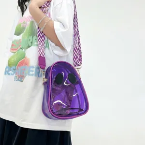 Detail of purple transparent PVC jelly bag with black oval accents and patterned strap