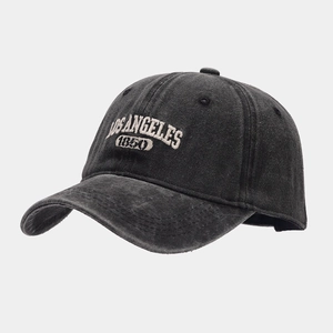 Detail of embroidered Los Angeles 1850 text on washed dark grey baseball cap