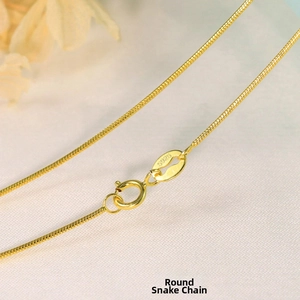 Close-up of golden S925 sterling silver round snake chain necklace with spring clasp