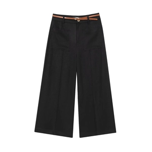Detail of black wide-leg linen trousers featuring large pockets and a slim brown belt