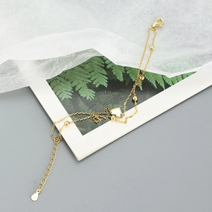 Detail of s925 silver double-layer golden heart bracelet with small beads and lobster clasp