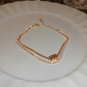 Elegant gold double layer bracelet with cubic zircon square slider and dainty chain