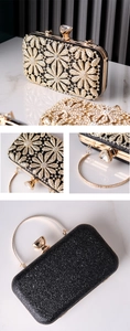 Detail view of sparkling rhinestone flower accents on a luxury black evening clutch bag