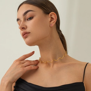 Close-up of minimalist 18k gold-plated stainless steel wavy choker on female neck