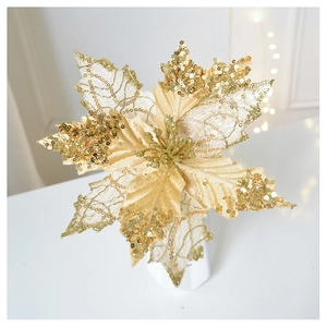 Close-up of golden glitter poinsettia Christmas flower in white vase with warm bokeh lights