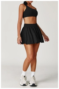 Detail of black sports set featuring a one-shoulder top with 3D floral decoration