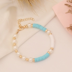 Detail of blue and white polymer clay bead bracelet with pearls and adjustable gold clasp