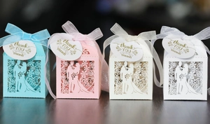 Laser cut wedding favor boxes with silk ribbons and Thank You tags in four pastel colors