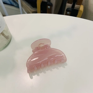 Pink translucent heart hair claw clip in acrylic finish for elegant hairstyling