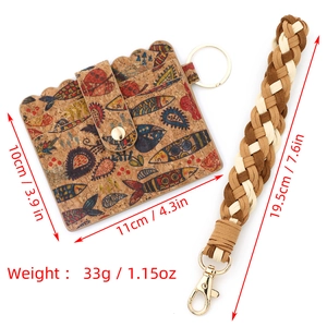 Cork card wallet with colorful fish print and woven wristlet strap on white background
