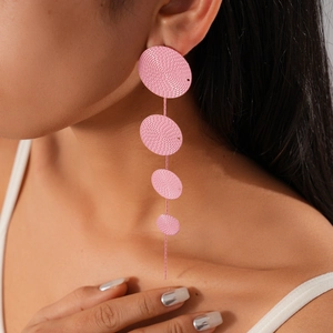 Detail of pink tiered circular drop earrings with textured concentric ripple patterns