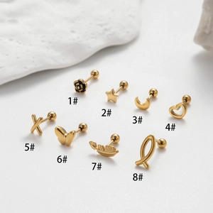 Eight assorted gold stainless steel stud earrings with star and flower designs