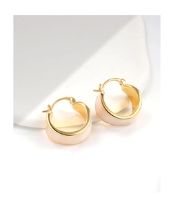 Macro detail of 18K gold plated hoop earrings featuring cream white enamel glaze finish