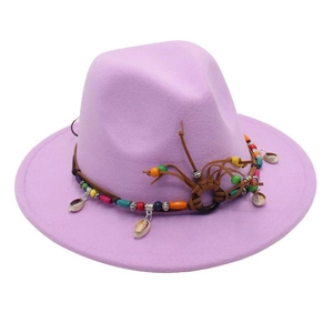 Detail of light purple wool fedora featuring bohemian braided rope with beads and shells