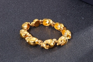 Detailed view of punk style gold skull bracelet made of high quality metal alloy links