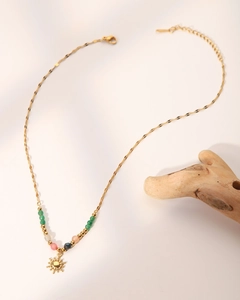 Detail of 18K gold-plated sun pendant necklace with vibrant colorful natural stone beads