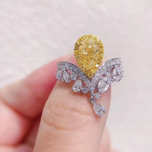 Luxury crown ring with a pear-shaped yellow diamond and V-shaped white diamond accents