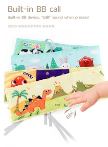 Close-up of double-sided soft baby book with dinosaur theme and built-in squeaker toy