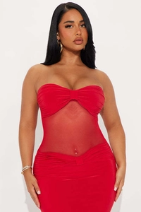 Close-up of red bodycon dress with sheer mesh panel and ruched chest detail
