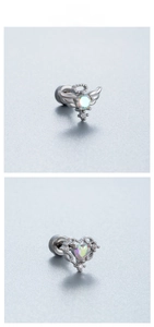 Détail de boucles d'oreilles aile de papillon et cœur avec zircons colorés à vis