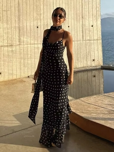 Detailed view of polka dot maxi dress with matching neck scarf and ruffle hem design