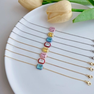 Detailed shot of S925 silver enamel bracelets with colorful zircon stones on a white tray