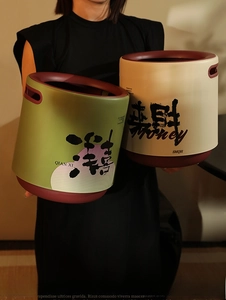 Detail of luxury olive green trash bin featuring Chinese calligraphy and handle