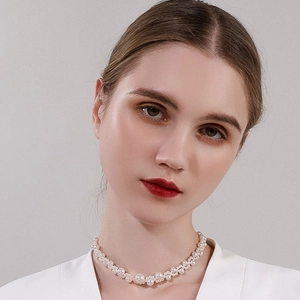 Minimalist woven faux pearl choker necklace for women with elegant white pearls worn by model