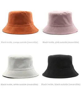 Detail of reversible corduroy bucket hats showing orange, pink, white, and black colors
