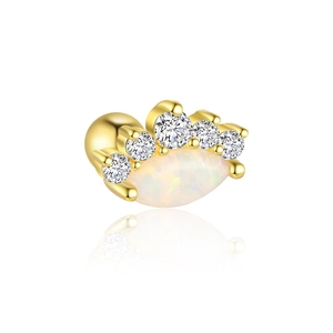 Macro shot of gold S925 silver stud earring with opal stone and sparkling diamonds