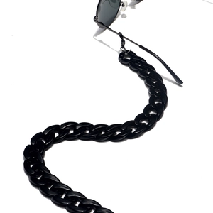 Large black acrylic links chunky eyewear chain attached to frame in S-shape curve