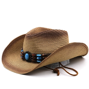 Close-up of woven straw cowboy hat with decorative beaded band and blue turquoise stone