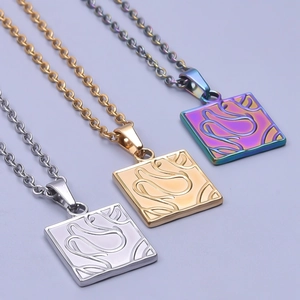 Detail of square 18k gold plated pendants in silver gold and rainbow finish