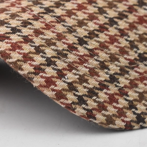 Dettaglio macro del motivo pied-de-poule spesso sulla visiera del cappello