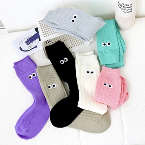 Flat lay of colorful ribbed cotton socks with cartoon big eye embroidery details