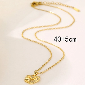 18k gold plated heart necklace with clear zircons on soft beige fabric background