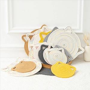 Detail view of cat-shaped braided cotton heat resistant placemats in multiple colors