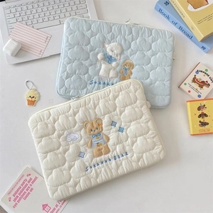 Close-up of quilted cloud pattern and cute bear embroidery on 13 inch laptop sleeve