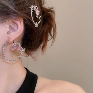 Detail of crystal hollow cat earrings and hair clip set worn on a model's ear