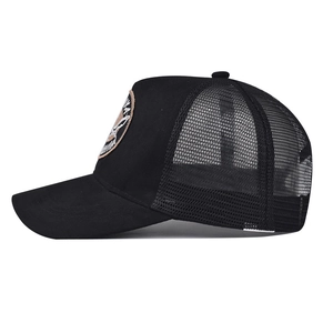 Detail view of the breathable black mesh and embroidered patch on the trucker baseball cap