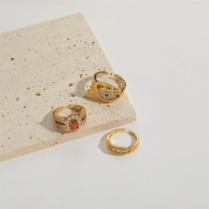 Three-piece gold adjustable open rings featuring vintage evil eye and red gemstone charms