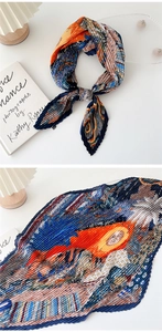 Detail of pleated silk scarf with navy and orange geometric art print texture