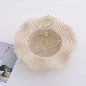 Detail of girls straw sun hat with inner adjustable drawstring and elastic chin strap