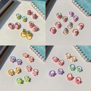 Detail view of elastic hair bands with resin fruit, floral and bow charms for girls