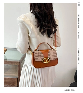 Close-up of contrast patchwork crossbody bag in caramel brown and houndstooth pattern